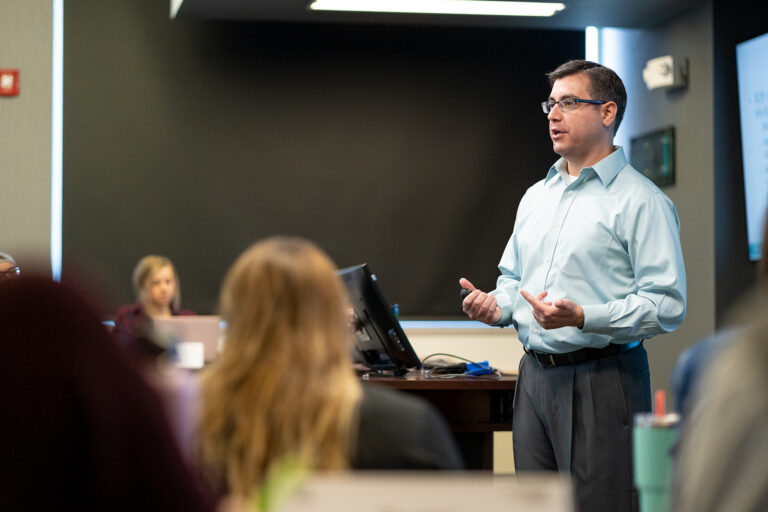 Jon Firooz, Instructor in the Marketing department in the College of Business working with students