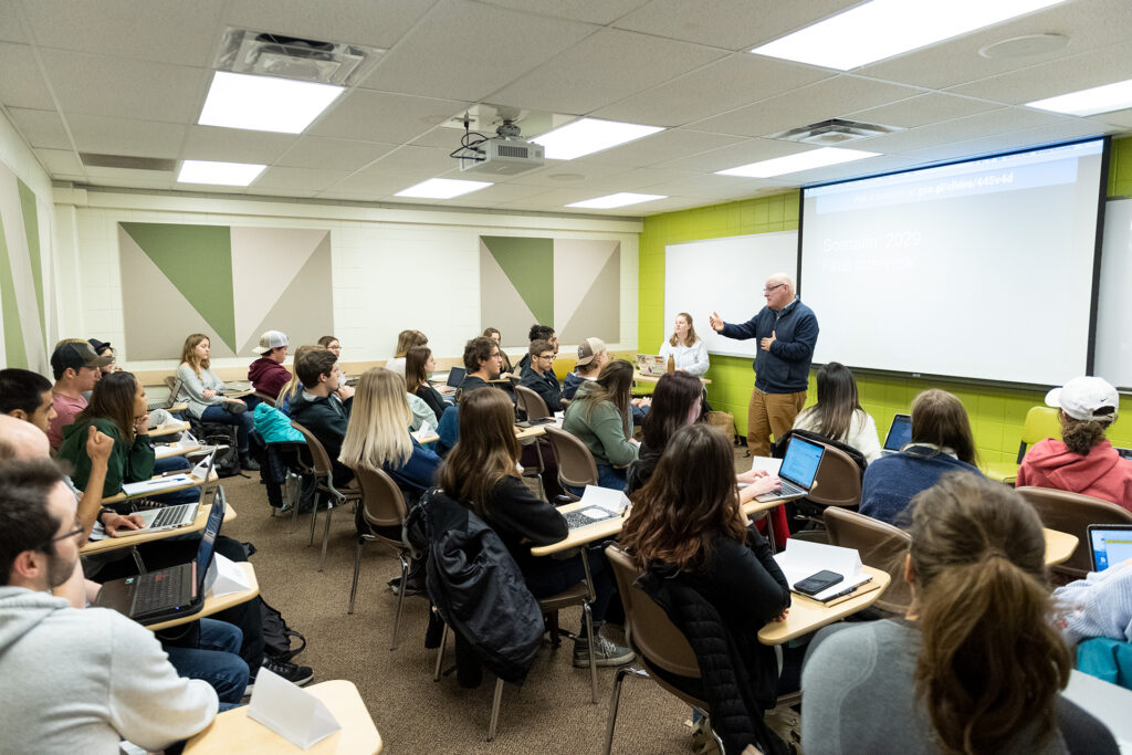 Michael Humphrey, Assistant Professor of Journalism and Media Communication in the College of Liberal Arts with students in class