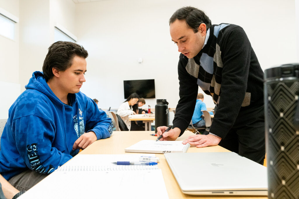 Engineering professors with directly with student during a lecture, Novebmer 7, 2019