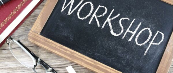 image of the word Workshop written on a small handheld chalkboard