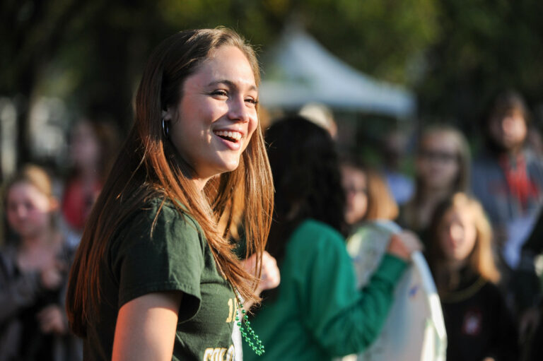 A student smiles in a crowd