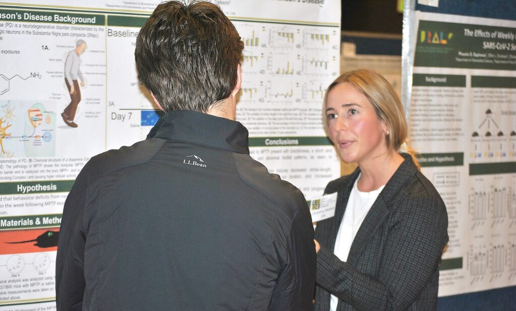 student describing her research during CURC
