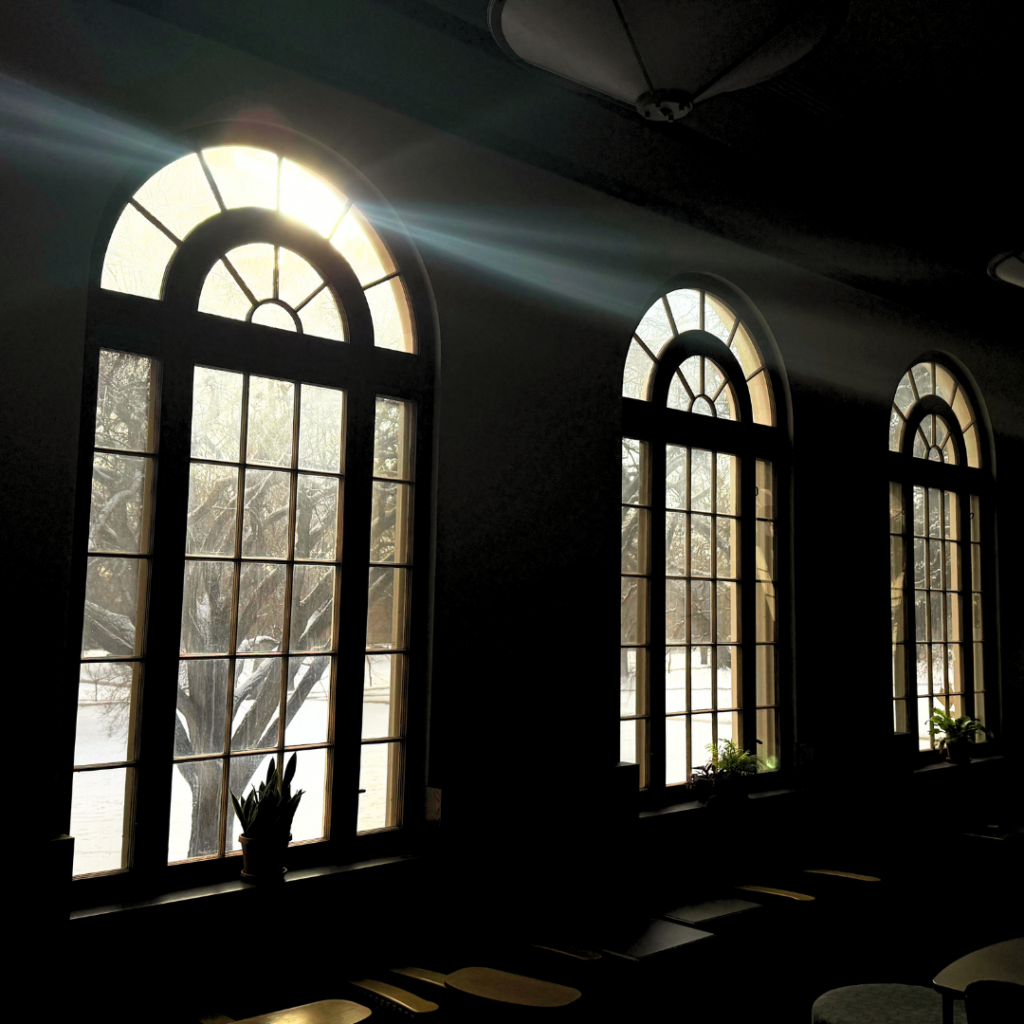 Photos of tall, round windows found in TILT's Great Hall